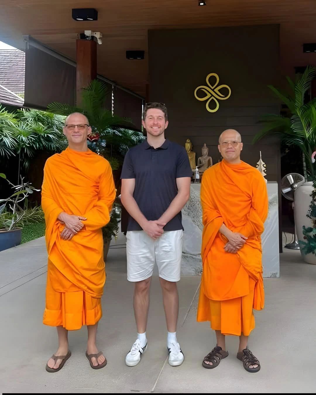 The monks with a member of the Miracles Asia team