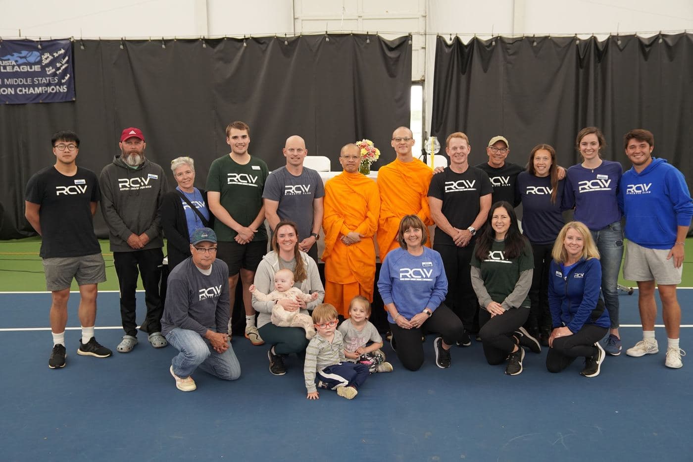 The monks with the RCW team on a tennis court